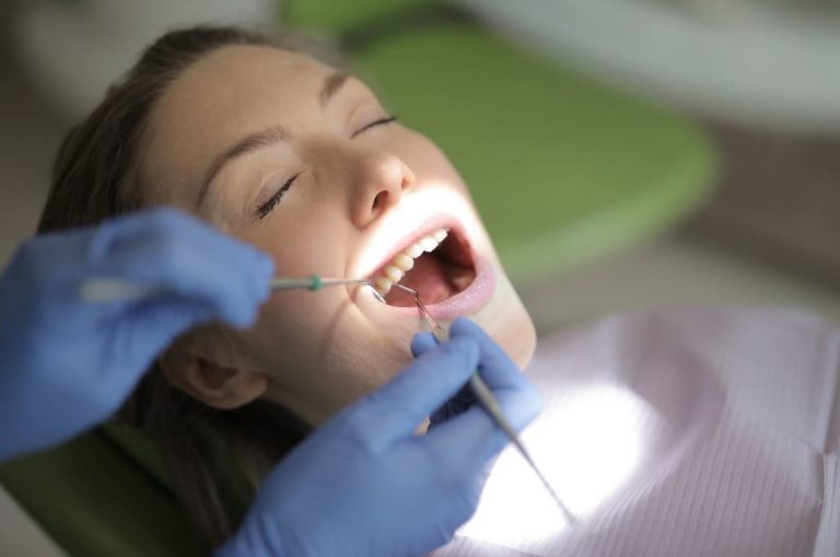Dentist Examing teeth in Katy Texas